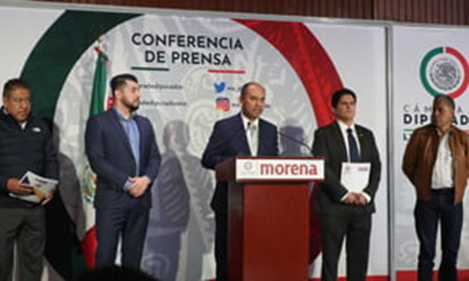A group of men standing at a podiumDescription automatically generated